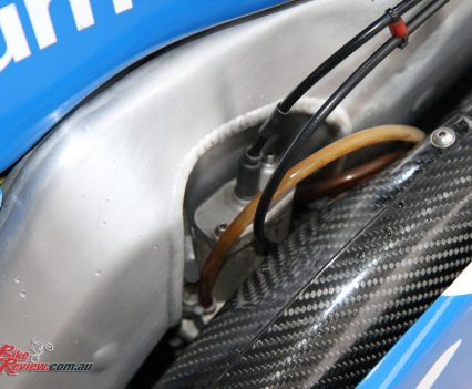 The frame is specifically built around the rear carburetor, showing the level of detail that goes into this level of GP machinery