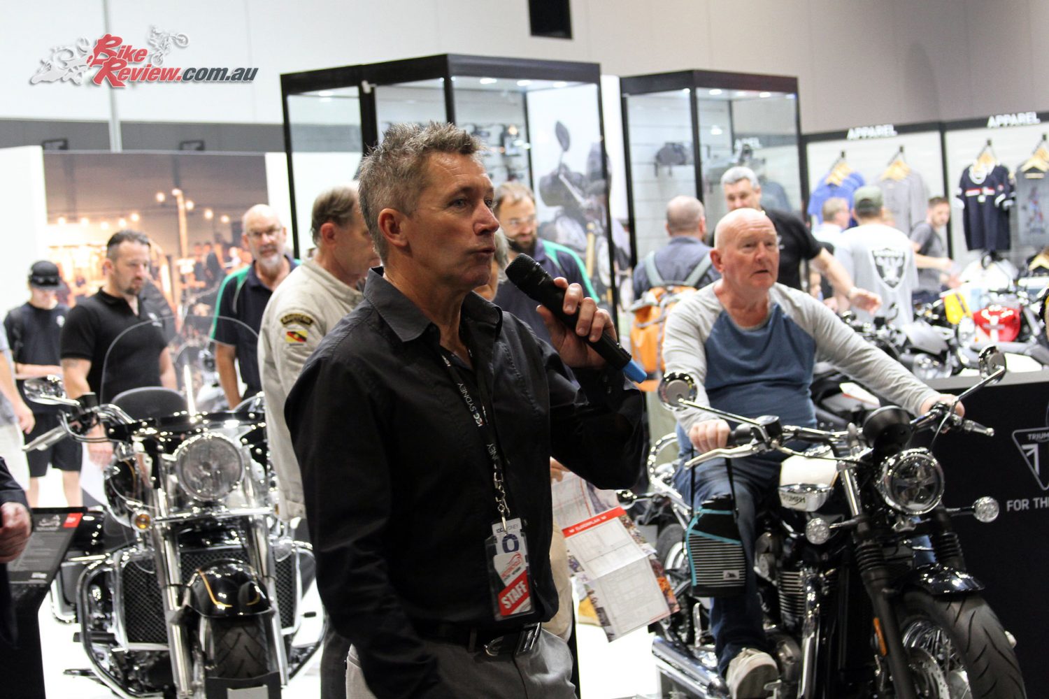 Troy Bayliss introduces the show in front of the Triumph stand