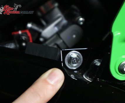 Front bolt seen here, just near where the green and black fairing pieces join