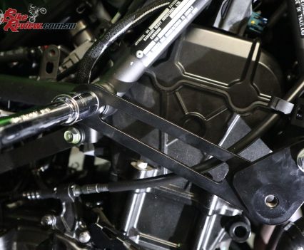 Remove and replace the standard bolt with the provided bolt, spacer and washer holding the bracket in place