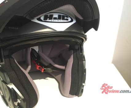 The face shield opens via a single release button.