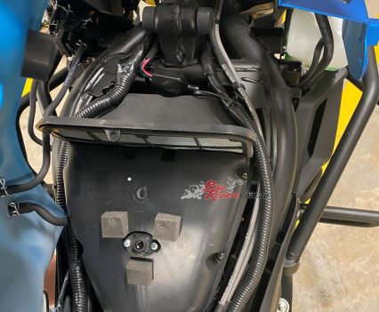 The airbox located under tank should be easy enough to remove.