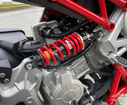 The rear shock is in a more conventional location. Both are easy to access for adjustment.