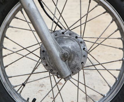 The front wheel was wire wheeled, then Jeff adjusted the spokes, stripped the hub paint and fitted new wheel bearings, tube and tyre.