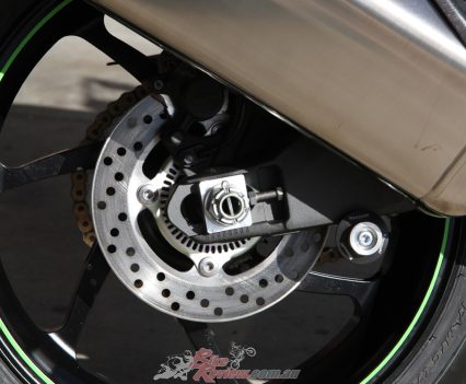 220mm rear rotor, Nissin single-bore pin-slide caliper.