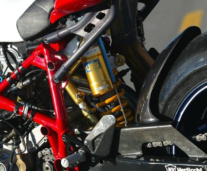 Composite cast/fabricated aluminium swingarm pivoting in engine crankcases and chassis, with rising rate linkage and Öhlins shock.